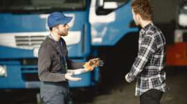 Instructor explaining truck inspection and training process to student at a truck driving school in Windsor Ontario.