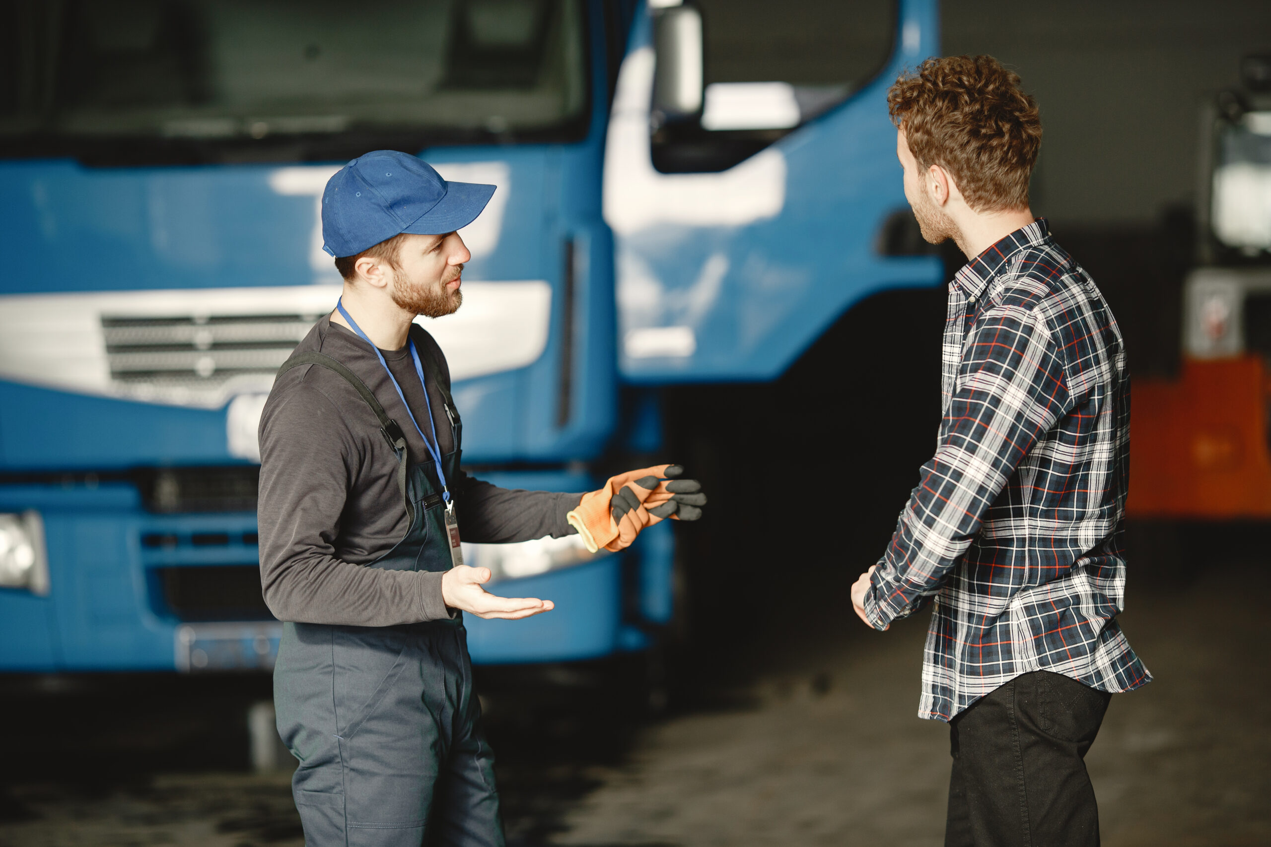 Instructor explaining truck inspection and training process to student at a truck driving school in Windsor Ontario.